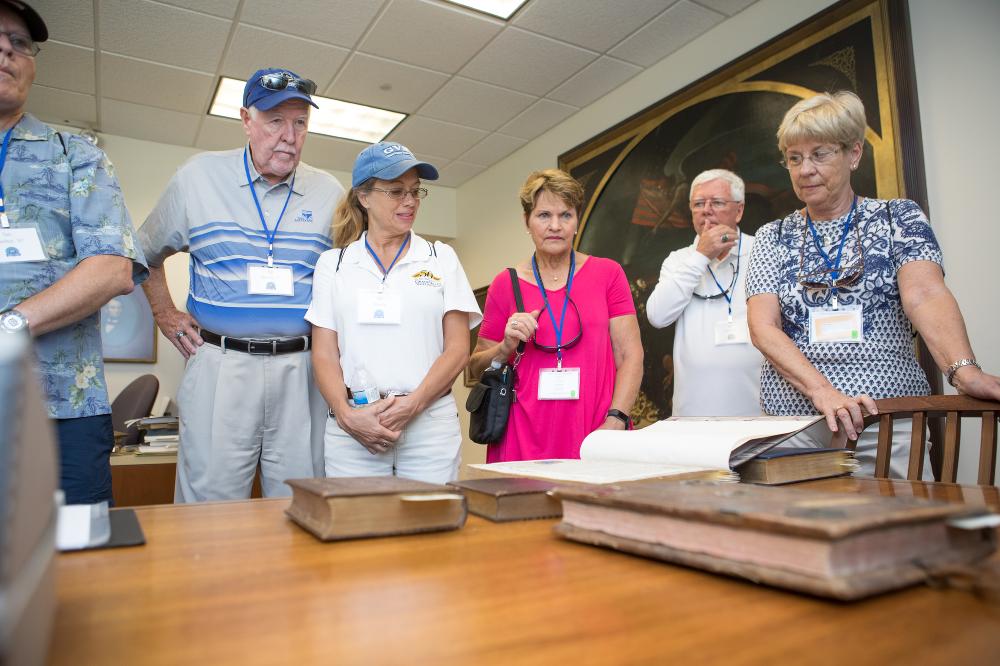 group looks at old books
